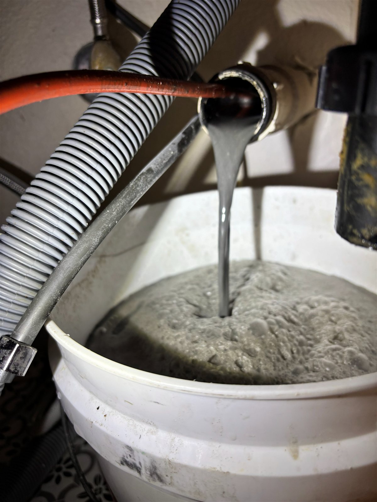 Hydrojetting actively flushing built-up sludge and debris out of a drain line